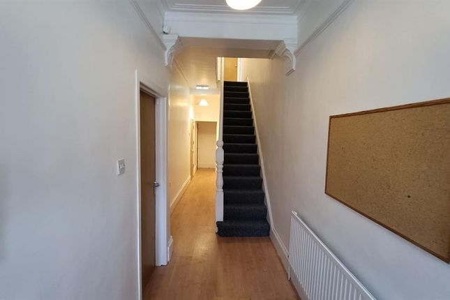 A Clean And Well-Maintained Hallway Featuring Wood...