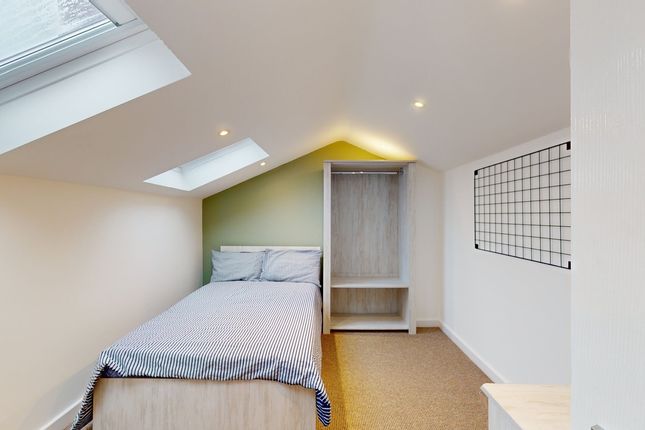 A Bright And Tidy Single Bedroom Featuring A Comfo...