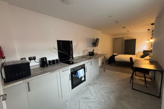 Modern Kitchenette Featuring Sleek Cabinetry And A...