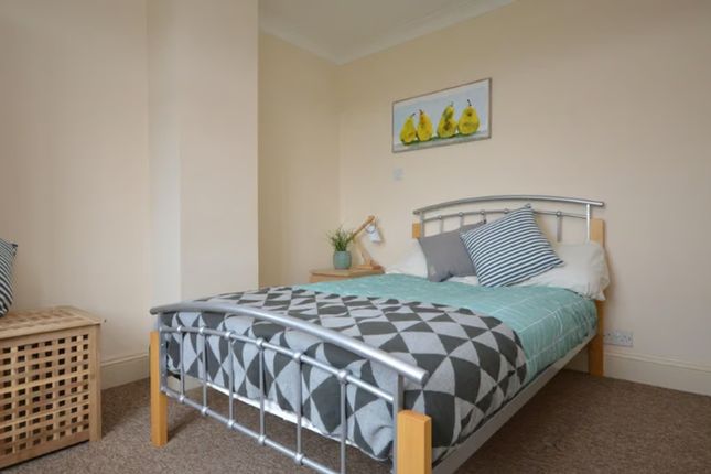 A Cozy Double Bedroom Featuring A Comfortable Bed ...