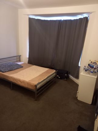 A Modest Bedroom With A Single Bed, A Small White ...