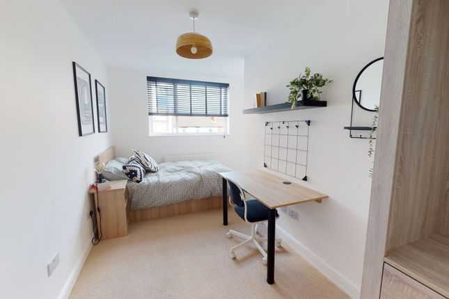 A Bright, Modern Bedroom Featuring A Comfortable d...