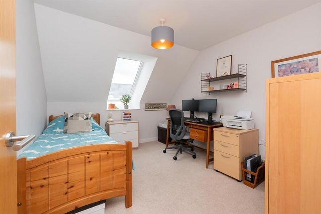 A Bright And Tidy Single Bedroom Featuring A Woode...