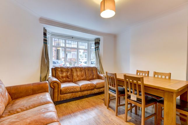 A Bright And Welcoming Living Room Featuring Comfo...