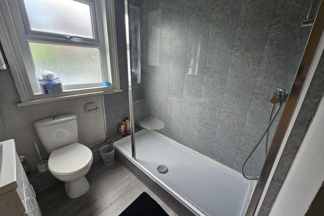 A Modern, Clean Bathroom With A Large Shower Area,...