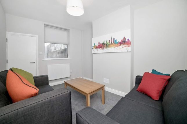 Bright, Modern Lounge With Two Grey Sofas Facing A...