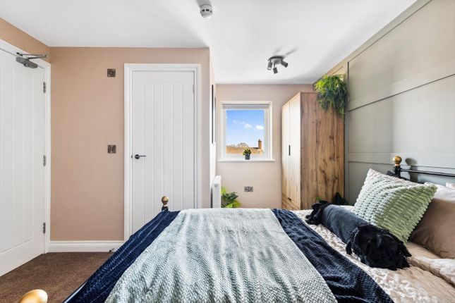 This Inviting Double Bedroom Features A Cozy Bed A...
