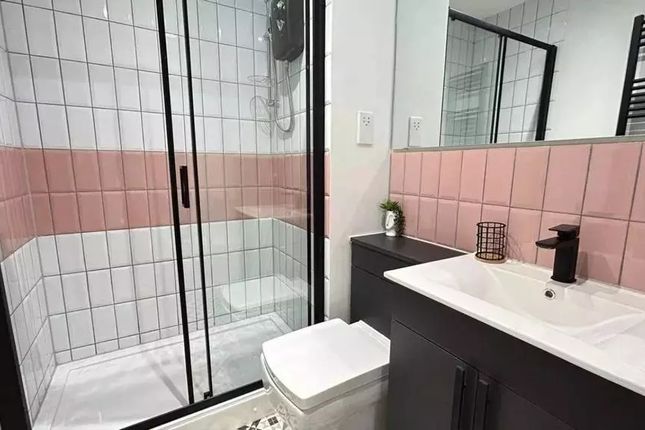 Bright And Modern Bathroom Featuring A Sleek Black...