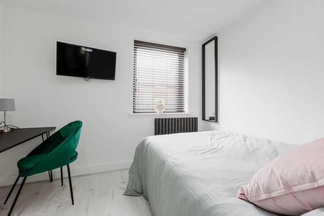 A Bright And Modern Bedroom Featuring A Double Bed...
