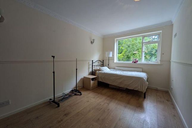 Cozy Single Bedroom Featuring A Large Window That ...