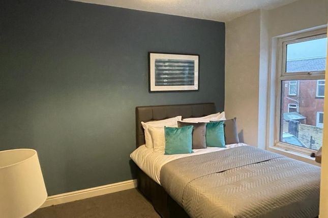 A Cozy Double Bedroom Featuring A Neatly Made Bed ...