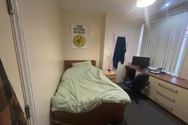 A Tidy Bedroom Featuring A Bed With A Light Green ...