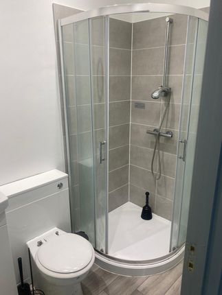 A Modern Bathroom Featuring A Spacious Shower Encl...