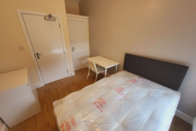 This Inviting Double Bedroom Features A Comfortabl...