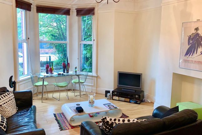 A Bright And Inviting Living Room Featuring Large ...