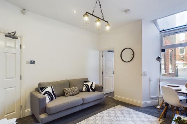 A Bright And Inviting Living Room Perfect For Soci...