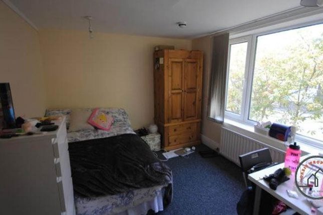 A Cozy Bedroom Featuring A Double Bed, A Wardrobe,...