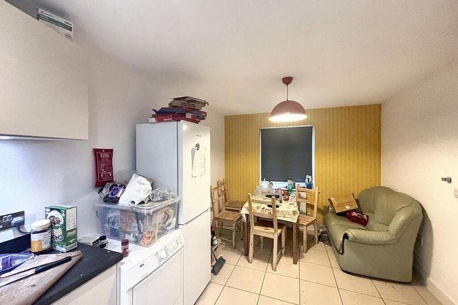 A Cozy And Well-Lit Living Room Featuring Comforta...