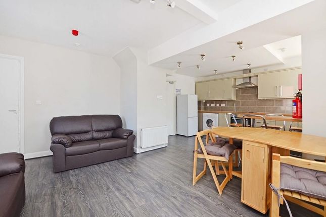 A Bright And Inviting Living Room Featuring Comfor...