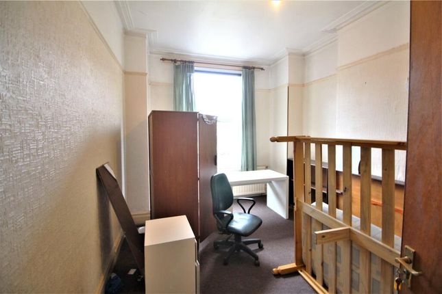 A Compact Single Bedroom Featuring A Study Desk Wi...