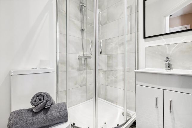 Modern Bathroom Suite Featuring A Spacious Shower ...