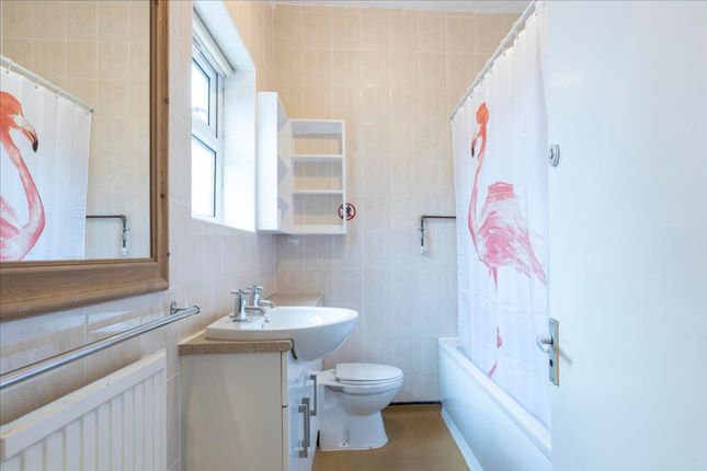 Bright And Tidy Bathroom Featuring A Relaxing Bath...