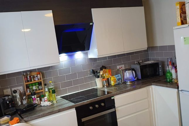 This Modern Kitchen Features Sleek Cabinetry And A...
