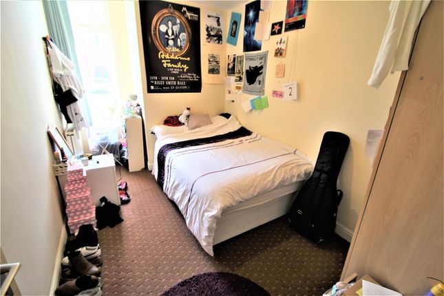 Bright And Cozy Single Bedroom With A Neatly Made ...