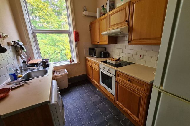 A Cozy Kitchen Featuring Wooden Cabinetry And Mode...