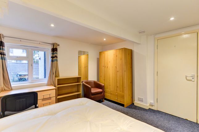 A Well-Maintained Bedroom Featuring A Comfortable ...