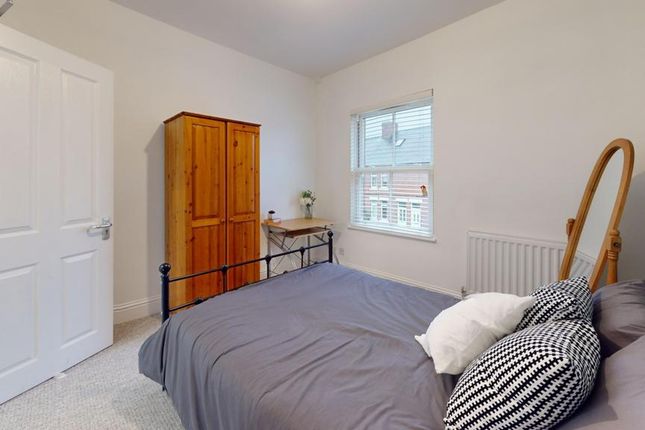 A Cozy And Well-Lit Double Bedroom Featuring A Com...