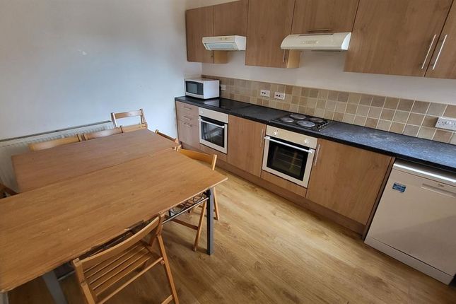 A Modern Kitchen Featuring Wooden Cabinetry, Built...