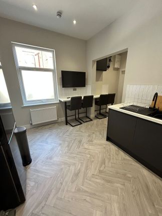 Modern Kitchen Area Featuring A Stylish Black-And-...