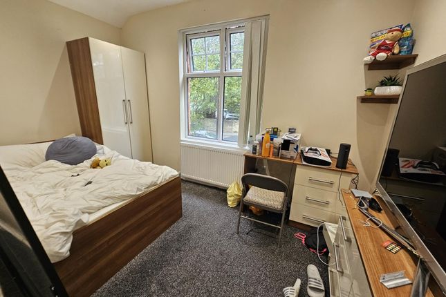 A Cozy Bedroom Featuring A Double Bed, A Wardrobe,...