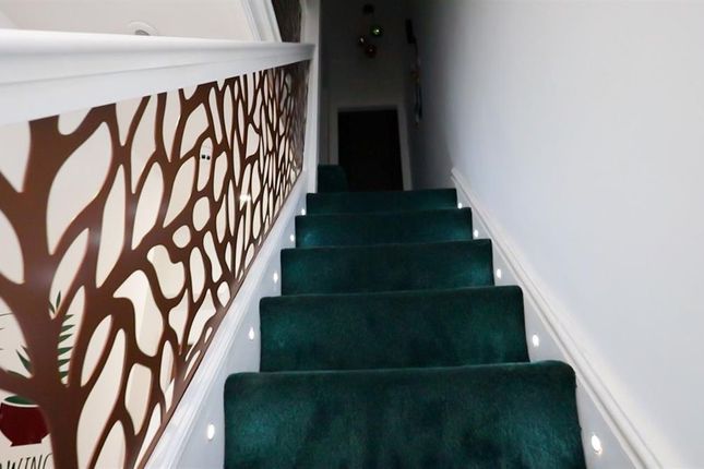 A Clean And Well-Maintained Staircase Featuring Gr...