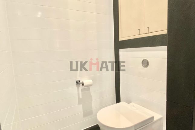 Modern Bathroom Featuring A Toilet With A Sleek De...