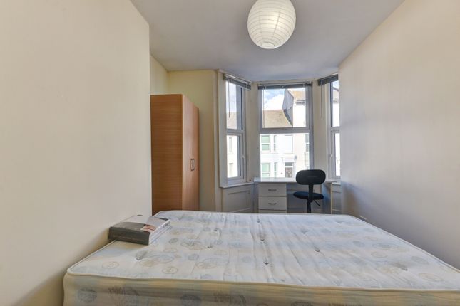 A Bright, Spacious Master Bedroom Featuring A Comf...