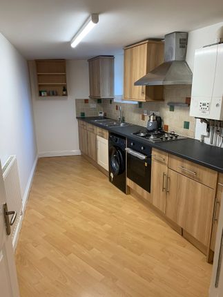 A Modern Kitchen Featuring Wood-Effect Cabinetry, ...