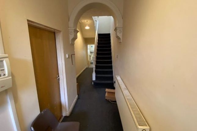 A Clean, Narrow Hallway With Neutral Walls And A d...