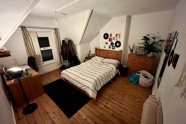 Bright, Neatly Arranged Double Bedroom With Wooden...