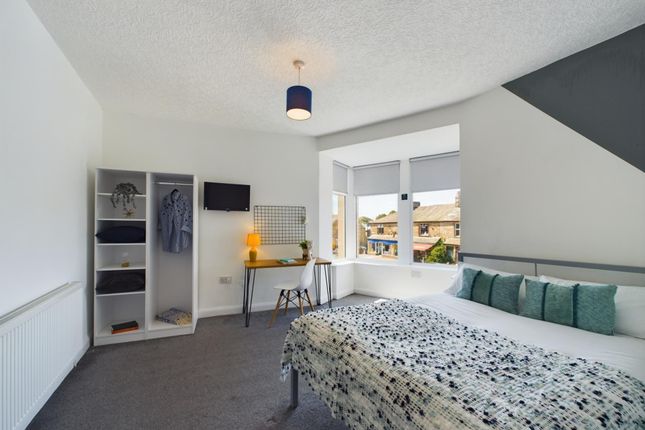 A Bright And Tidy Living Room Featuring A Large Wi...