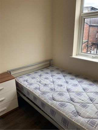 A Cozy Single Bedroom With A Large Window Allowing...