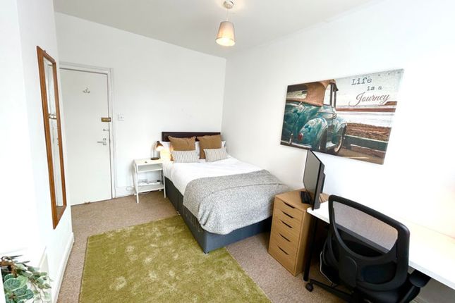 This Inviting Double Bedroom Features A Comfortabl...