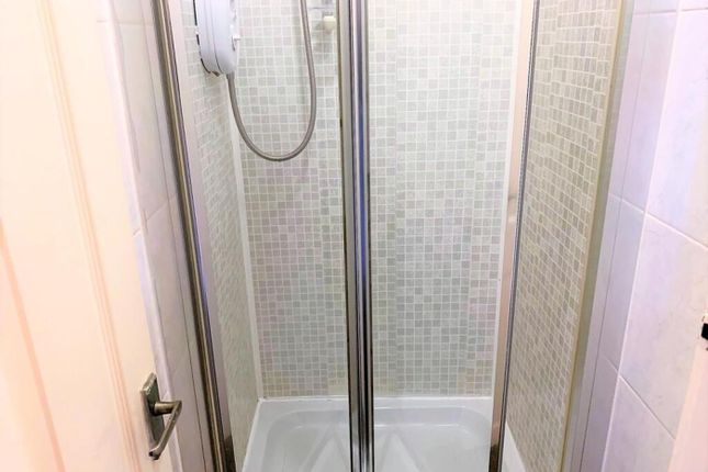 A Modern Bathroom Featuring A Sleek Shower Enclosu...