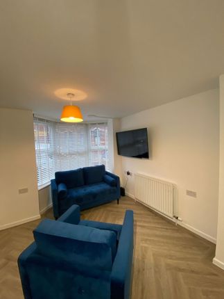 Modern Living Room Featuring A Comfortable Blue So...