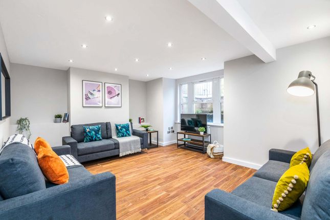 Bright And Spacious Living Room Featuring Modern F...