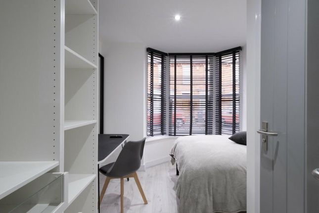This Inviting Double Bedroom Features A Cozy Layou...