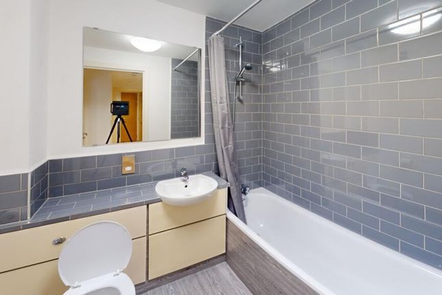 A Modern And Clean Bathroom Featuring Stylish Grey...