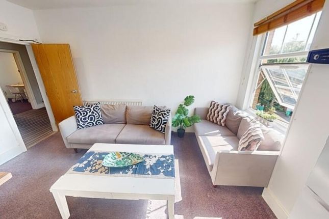 Bright And Welcoming Living Room Featuring Two Com...