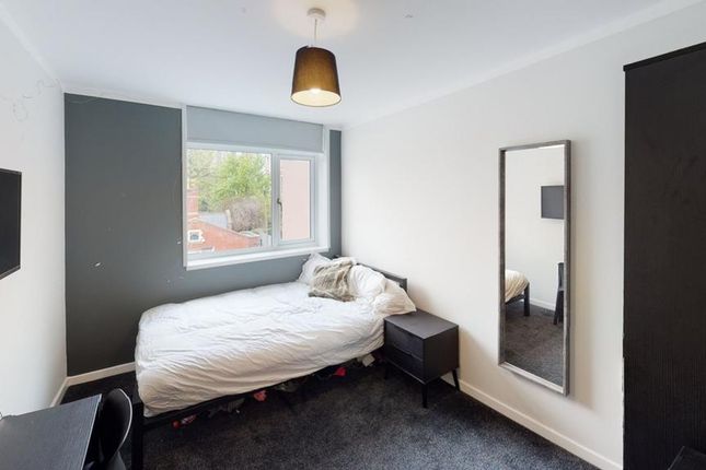 A Cozy Double Bedroom Featuring A Large Window, St...